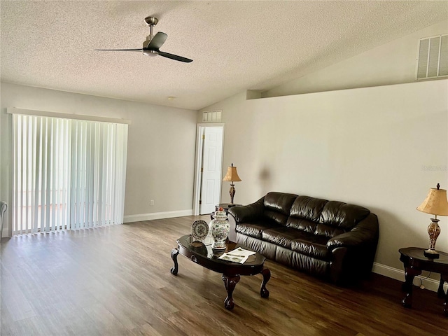 living room with ceiling fan, dark hardwood / wood-style flooring, vaulted ceiling, and a textured ceiling