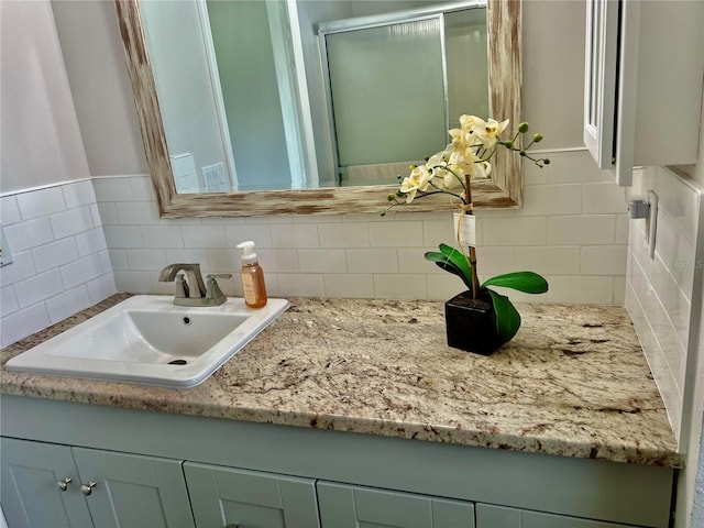 bathroom featuring vanity and decorative backsplash