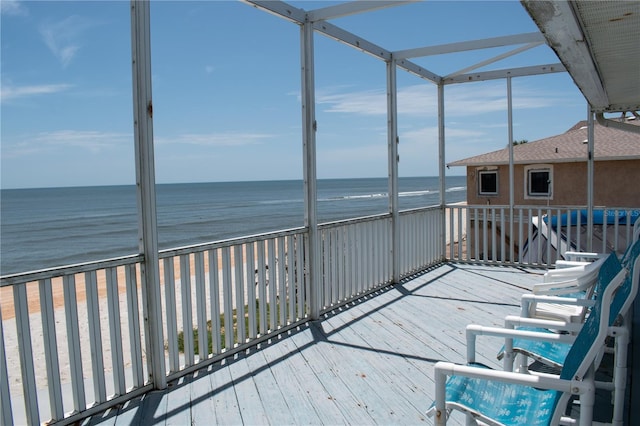 unfurnished sunroom featuring a water view