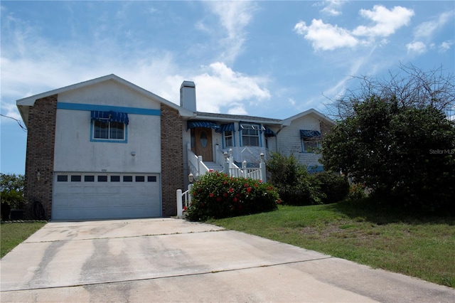 view of front of home with a garage and a front lawn