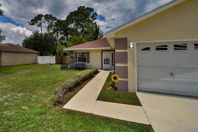 view of front of property featuring a garage and a front lawn