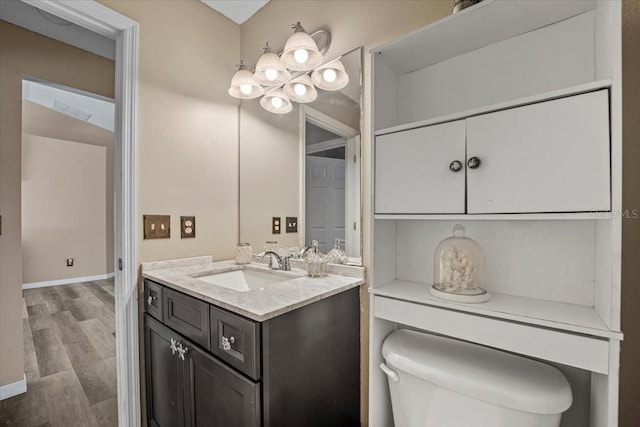 bathroom featuring hardwood / wood-style flooring, vanity, and toilet