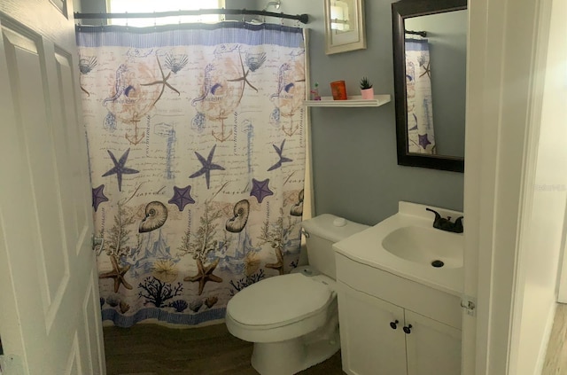 bathroom featuring hardwood / wood-style floors, vanity, a shower with shower curtain, and toilet