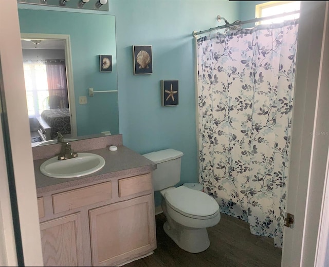 bathroom featuring a shower with curtain, vanity, hardwood / wood-style floors, and toilet