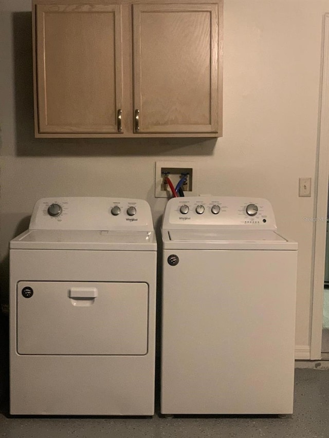 laundry room with cabinets and washing machine and clothes dryer