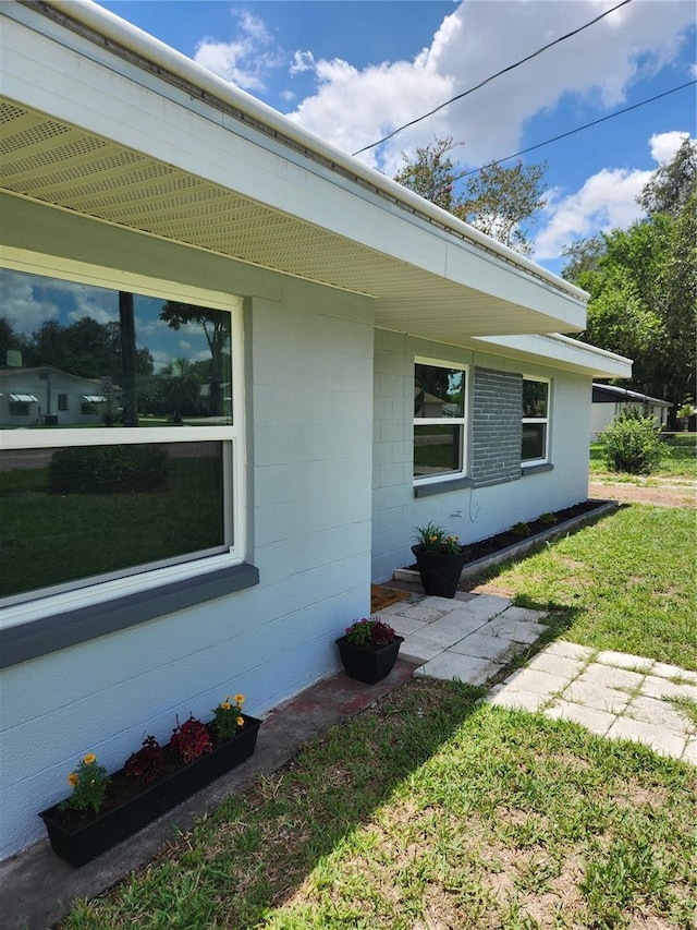 view of side of home with a yard