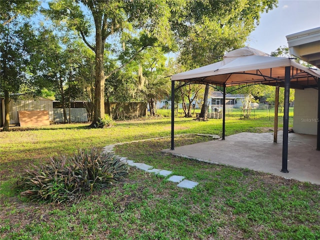 view of yard featuring a gazebo and an outdoor structure