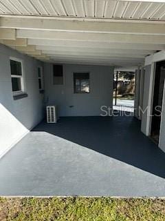 view of patio / terrace with a carport and cooling unit