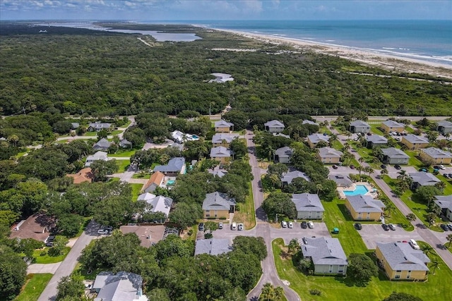 birds eye view of property with a water view and a view of the beach