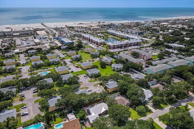 birds eye view of property featuring a water view and a beach view