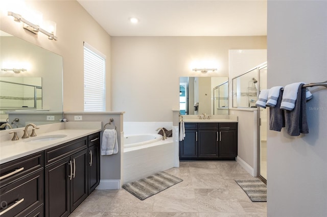 bathroom featuring vanity and separate shower and tub