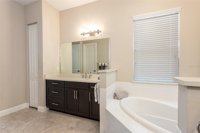 bathroom featuring vanity, tiled bath, and tile patterned floors