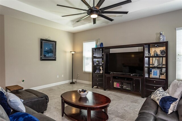 living room with ceiling fan and a healthy amount of sunlight