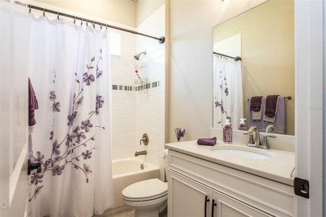 full bathroom with shower / bath combo with shower curtain, vanity, and toilet