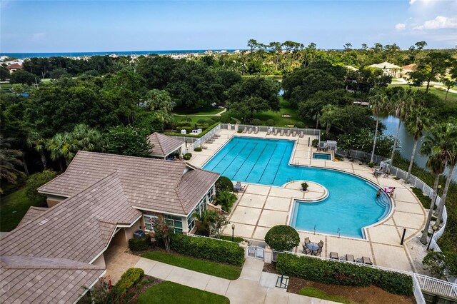 view of pool with a water view and a patio area