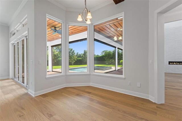 12245 Park Ave, Windermere, FL 34786 - unfurnished dining area with light wood-type flooring, a chandelier, crown molding, and baseboards