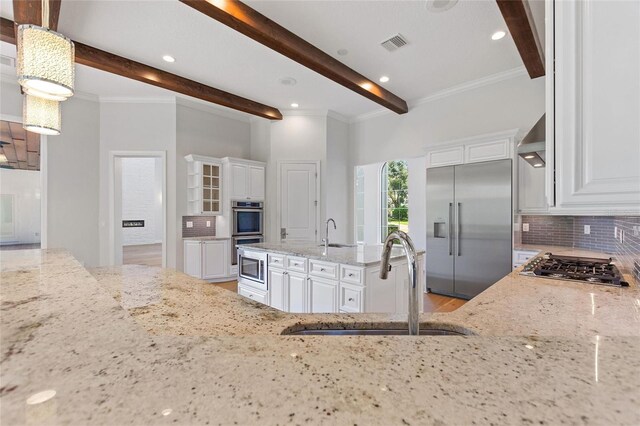 12245 Park Ave, Windermere, FL 34786 - kitchen featuring built in appliances, a sink, beam ceiling, decorative backsplash, and light stone counters