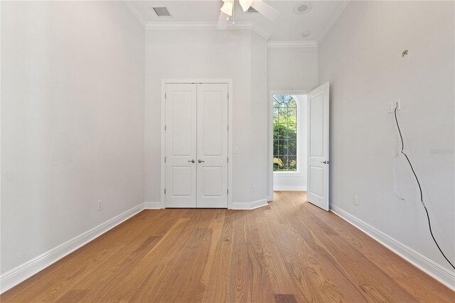 12245 Park Ave, Windermere, FL 34786 - unfurnished bedroom featuring ornamental molding, light wood finished floors, baseboards, a closet, and a ceiling fan