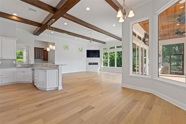 12245 Park Ave, Windermere, FL 34786 - kitchen with a ceiling fan, beam ceiling, stainless steel dishwasher, healthy amount of natural light, and light wood finished floors