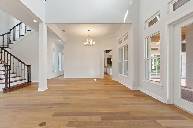 12245 Park Ave, Windermere, FL 34786 - foyer entrance featuring a chandelier, healthy amount of natural light, stairway, ornamental molding, and baseboards
