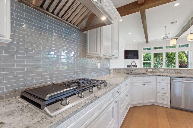 12245 Park Ave, Windermere, FL 34786 - kitchen featuring appliances with stainless steel finishes, custom range hood, a sink, decorative backsplash, and light wood-type flooring