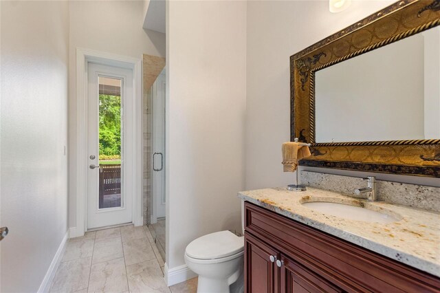 12245 Park Ave, Windermere, FL 34786 - bathroom featuring baseboards, a shower stall, vanity, toilet, and marble look tile flooring