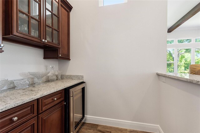 12245 Park Ave, Windermere, FL 34786 - indoor dry bar with beverage cooler, healthy amount of natural light, baseboards, and dark wood-type flooring