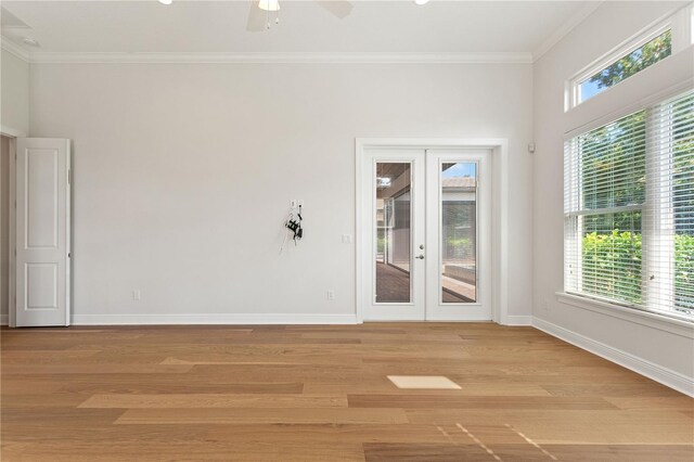 12245 Park Ave, Windermere, FL 34786 - spare room featuring french doors, baseboards, ornamental molding, and light wood-type flooring