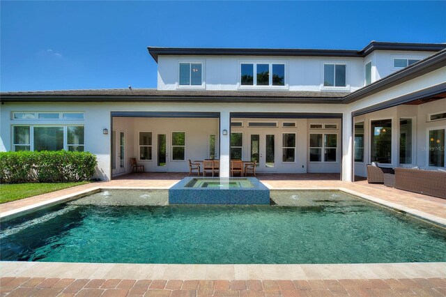 12245 Park Ave, Windermere, FL 34786 - back of house featuring an in-ground hot tub, an outdoor pool, and a patio