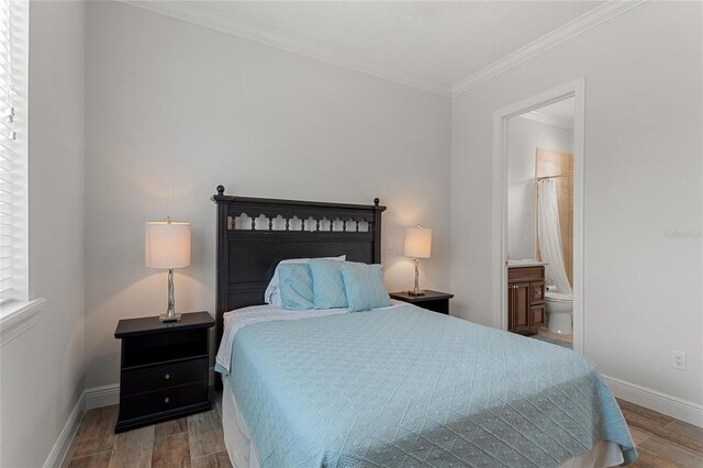 12245 Park Ave, Windermere, FL 34786 - bedroom featuring wood finished floors, baseboards, crown molding, and ensuite bathroom