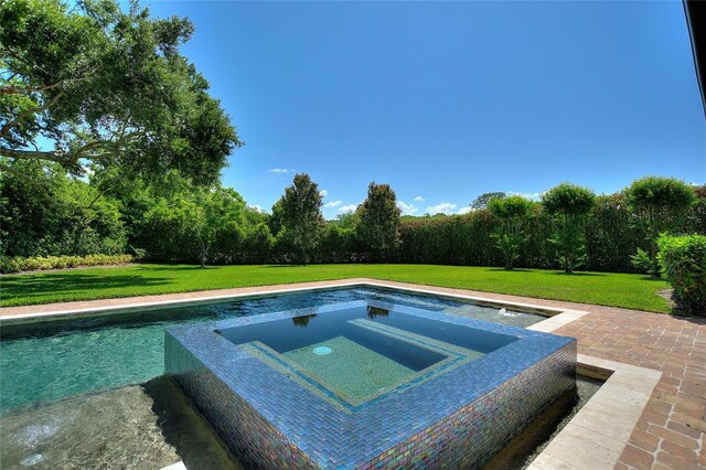 12245 Park Ave, Windermere, FL 34786 - view of swimming pool with an in-ground hot tub and a lawn