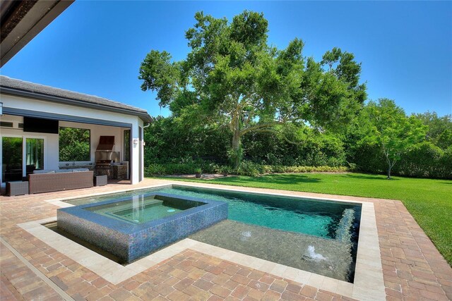 12245 Park Ave, Windermere, FL 34786 - outdoor pool featuring exterior kitchen, an in-ground hot tub, a lawn, a patio area, and an outdoor hangout area