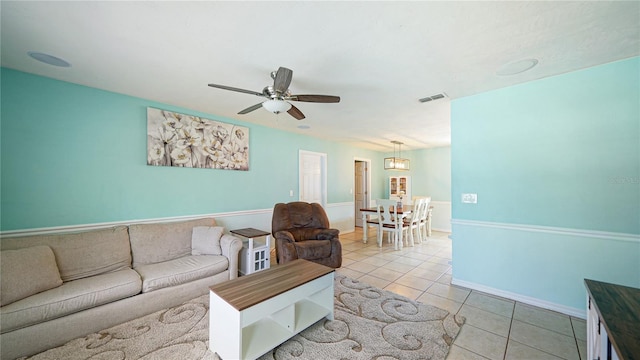 tiled living room with ceiling fan