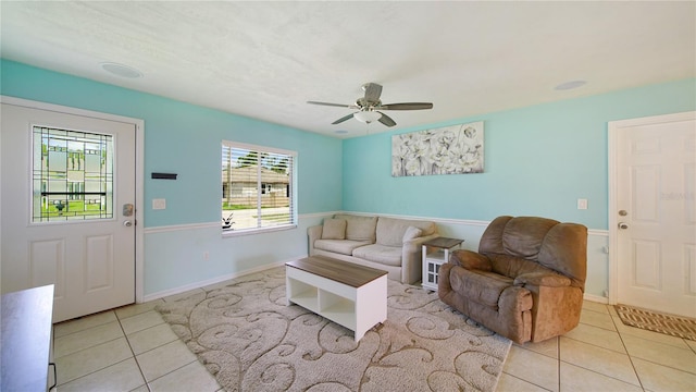 living room with light tile patterned flooring and ceiling fan