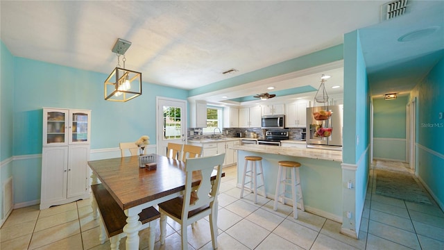 dining room with sink and light tile patterned floors