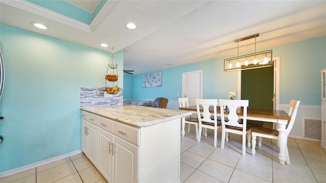 kitchen with white cabinetry, light tile patterned floors, hanging light fixtures, light stone countertops, and kitchen peninsula