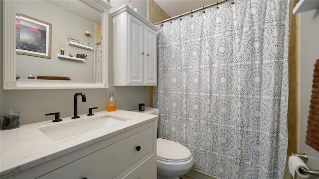 bathroom featuring vanity and toilet