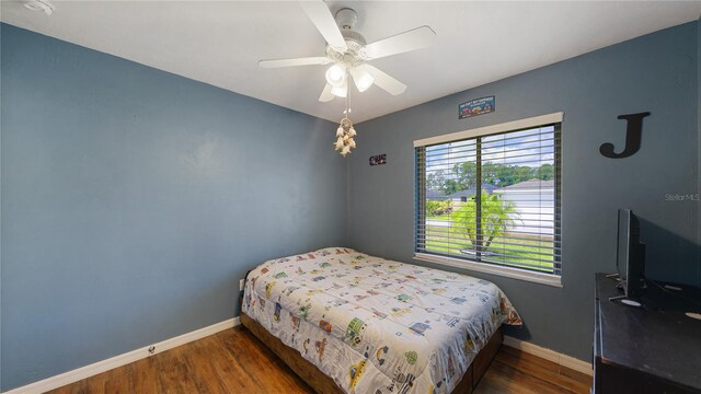 bedroom featuring dark wood-type flooring and ceiling fan