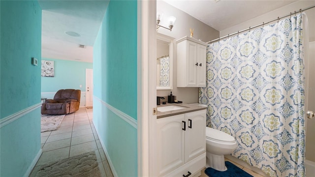 bathroom featuring vanity, toilet, and tile patterned floors