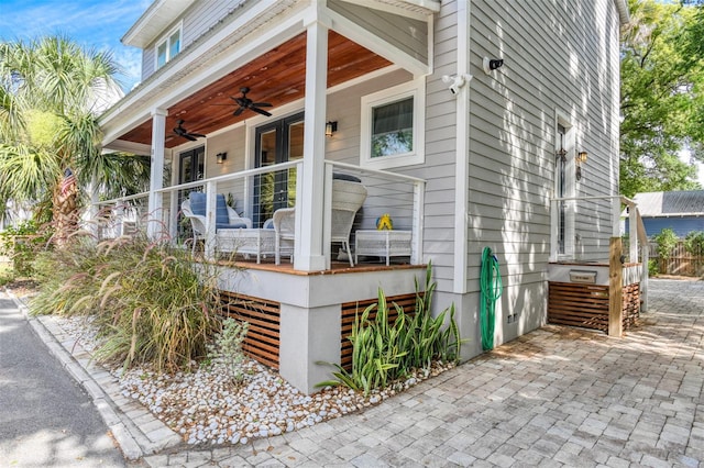 view of property exterior featuring ceiling fan and french doors