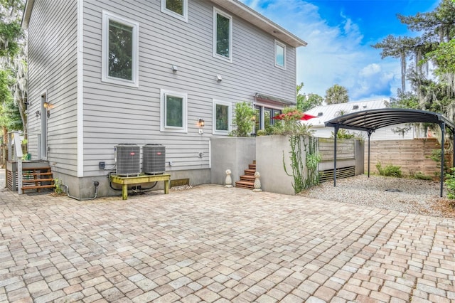 rear view of house with a patio and cooling unit