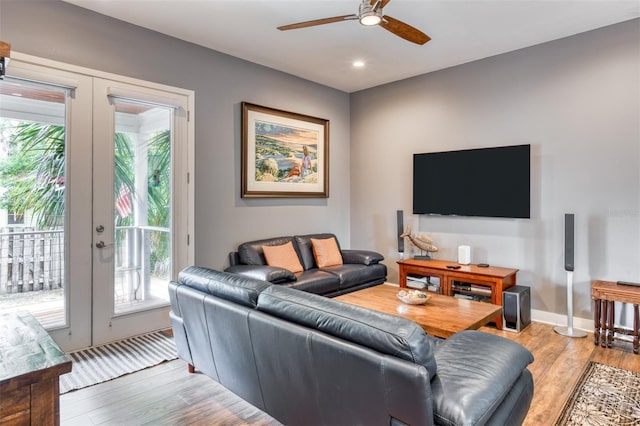 living room with ceiling fan, light hardwood / wood-style flooring, and french doors