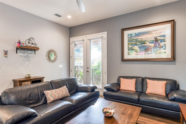 living room with french doors, a healthy amount of sunlight, and hardwood / wood-style floors