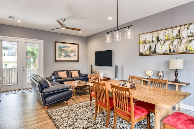 dining room featuring ceiling fan, light hardwood / wood-style floors, and french doors