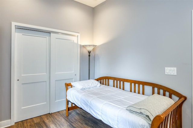 bedroom featuring dark wood-type flooring and a closet