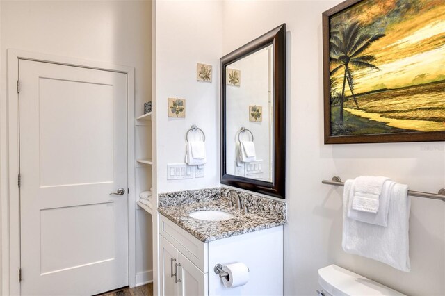 bathroom featuring vanity and toilet