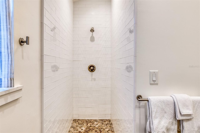 bathroom with a tile shower