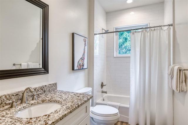 full bathroom featuring vanity, shower / tub combo, and toilet