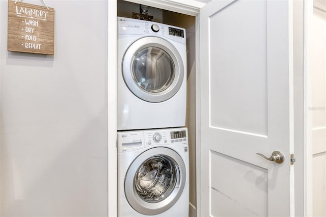 washroom with stacked washer and dryer