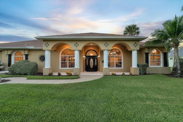 mediterranean / spanish-style home featuring a yard